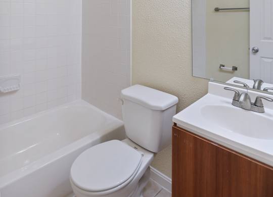 a bathroom with a toilet and a sink and a bath tub