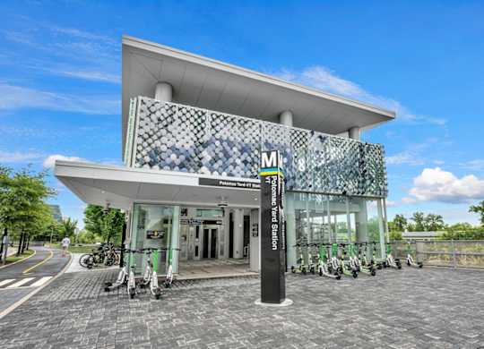A modern building with a glass facade and a white roof.