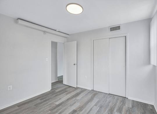 A room with a grey floor and white walls.