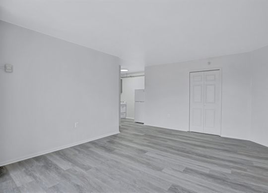 A room with a white door and a white cabinet.