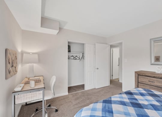 a bedroom with a bed and a desk
