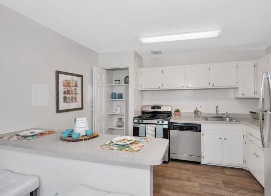 a kitchen with a counter top next to a stove top oven