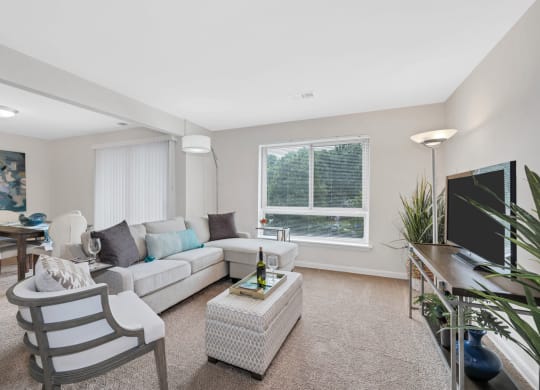 a living room with beige walls and carpet