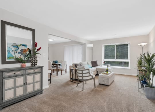 a living room with beige carpet and a white couch