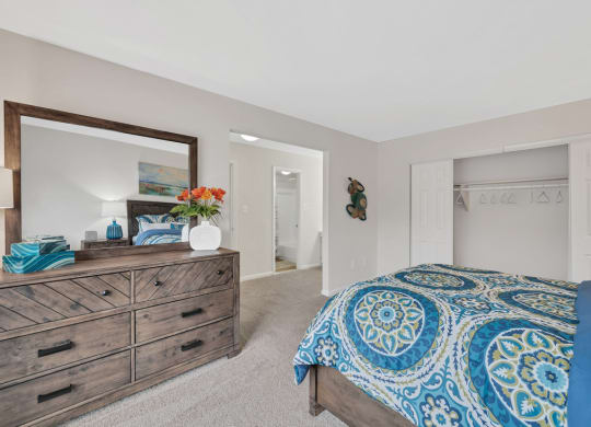 a bedroom with a bed and a dresser