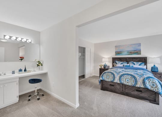 a bedroom with a bed and a desk with a chair