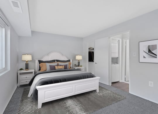 a bedroom with a large bed and a white closet