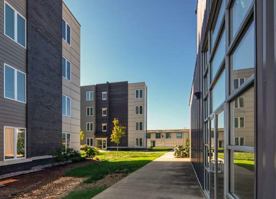 a view of an apartment building from a sidewalk
