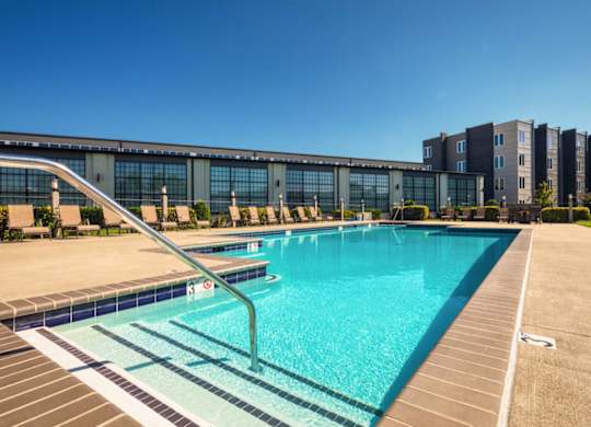 a swimming pool with a building in the background
