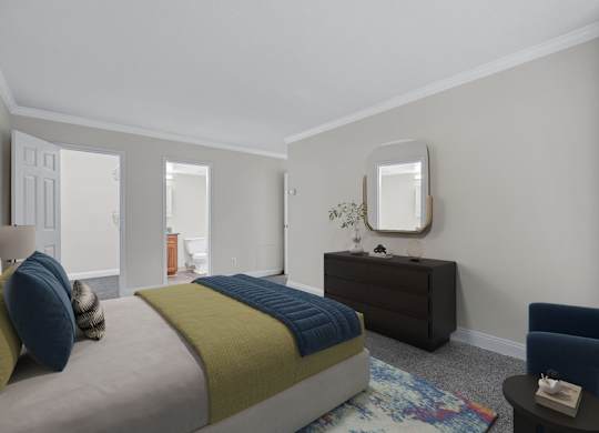 A bedroom with a bed, a dresser, a chair, and a mirror.