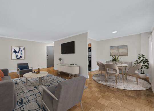 A living room with a grey couch, a white table, and a television.