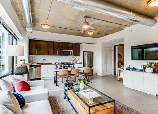 Modern apartment with kitchen, living room, and dining area.