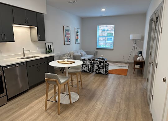 A kitchen with a dining table and chairs.