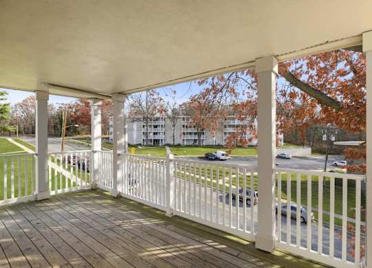 a porch with a view of a parking lot
