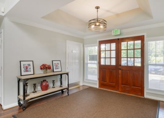 the entryway of a house with a wooden door and a window