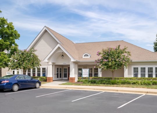 a building with a parking lot and a car in front of it