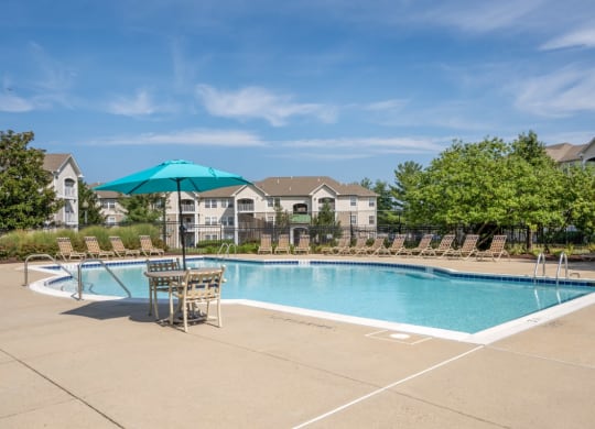 our apartments have a swimming pool with chairs and umbrellas