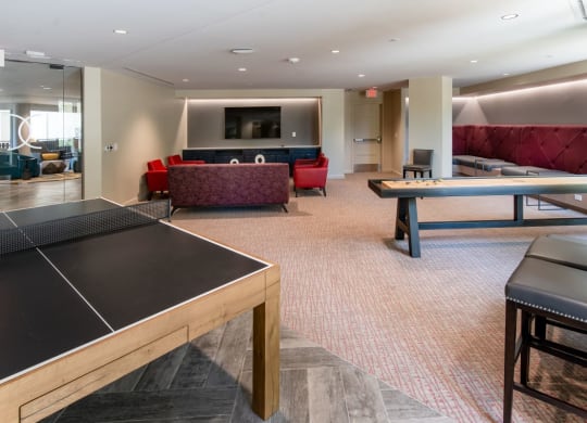 a game room with a ping pong table and couches