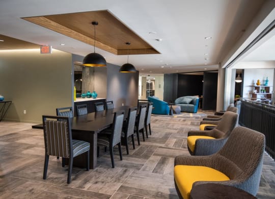 a long dining table with chairs in a lobby