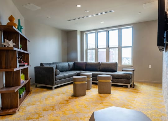 a living room with couches and tables in front of a window