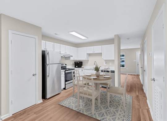 A kitchen with a table and chairs in the middle of the room.