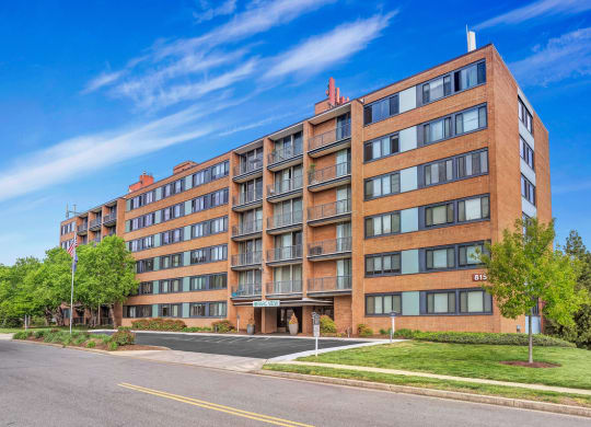 a large brick apartment building on the corner of a street