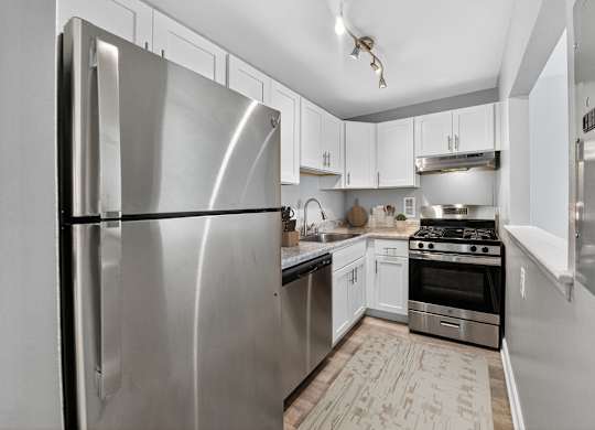 A modern kitchen with a stainless steel refrigerator.