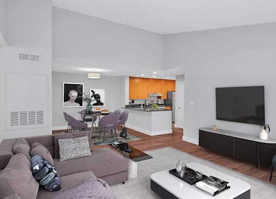 A furnished luxury apartment living room with large dining room and stylish kitchen in the background.