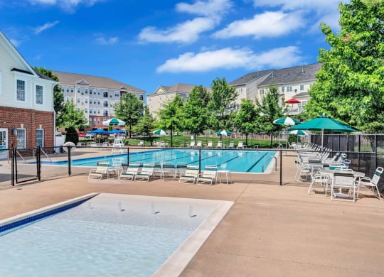 our apartments have a resort style pool with chairs and tables