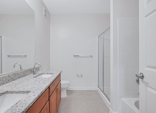 a bathroom with a sink and a shower and a toilet