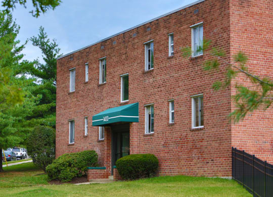 an old brick building with a green awning