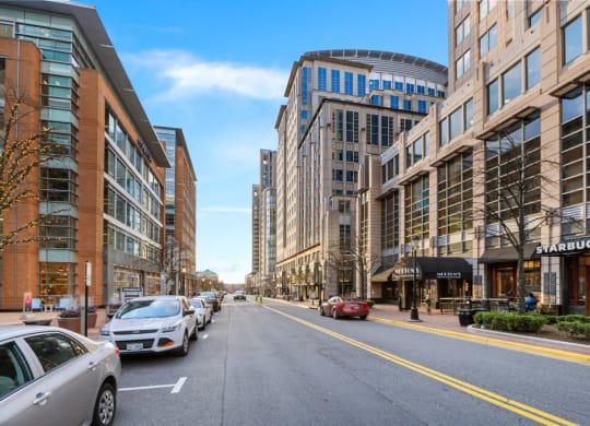 a street in a city with cars parked on the side of the road