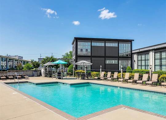 a large swimming pool in front of a hotel