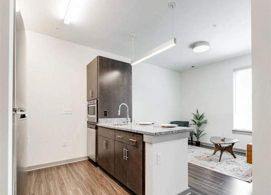 A kitchen with a white counter top and wooden cabinets.