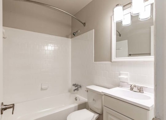 a bathroom with a sink toilet and a bath tub