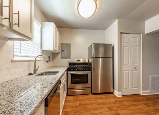 a kitchen with stainless steel appliances and a counter top