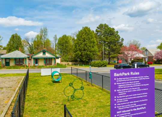 a sign for bath park rules in front of a tennis court