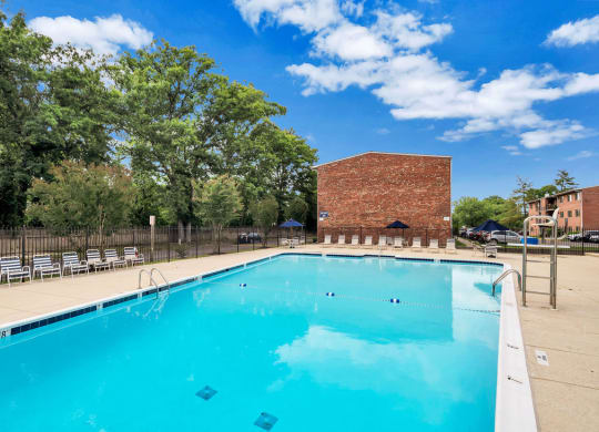 a swimming pool with a brick building in the background