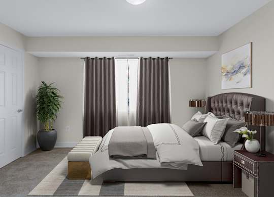 A bedroom with a large bed and a potted plant.
