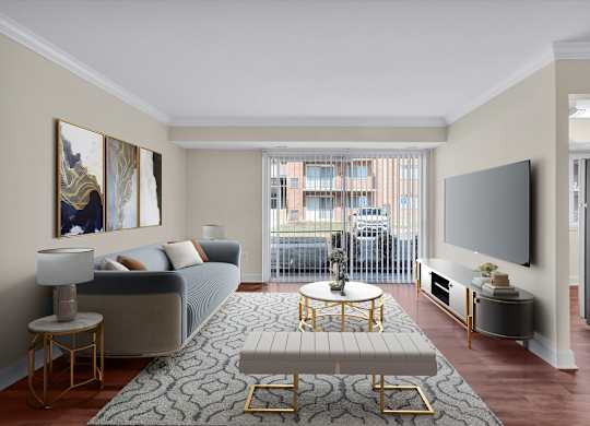 A living room with a grey couch, a round gold coffee table, and a large painting on the wall.