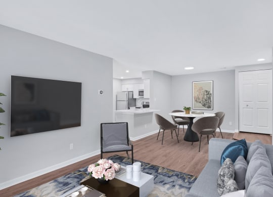 A contemporary living room featuring a sleek couch, a stylish table, and a state-of-the-art television.