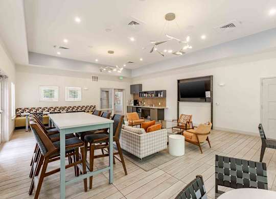 A spacious living room with a dining table and chairs.
