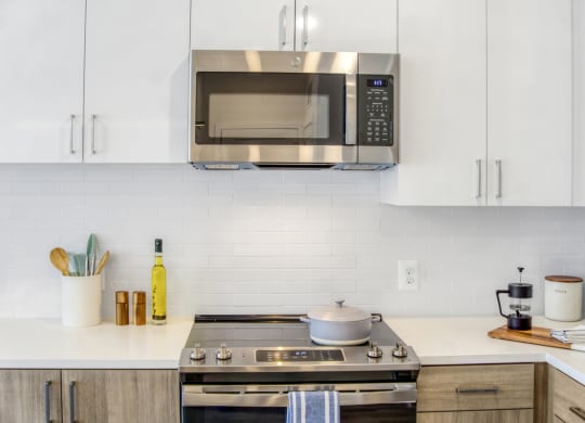 a kitchen with a stove top oven and a microwave