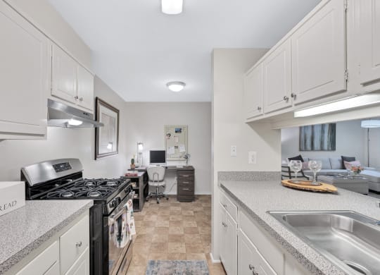 a kitchen with white cabinets and a black stove top oven