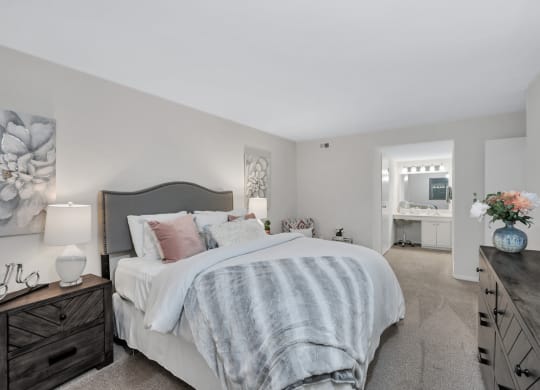 a bedroom with a bed and dresser