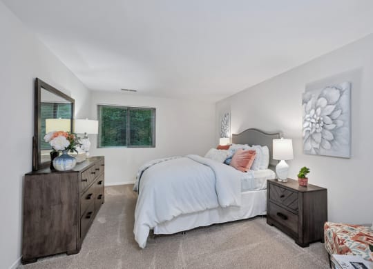 a bedroom with a large bed and two dressers