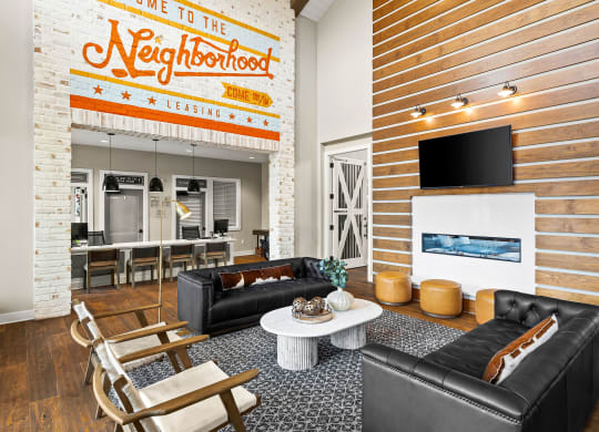 a living room with two leather couches and a white coffee table