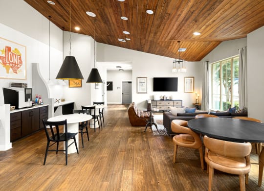 a living room with a table and chairs and a kitchen