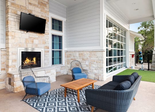 Outdoor Lounge with Fireplace and Comfy Seating