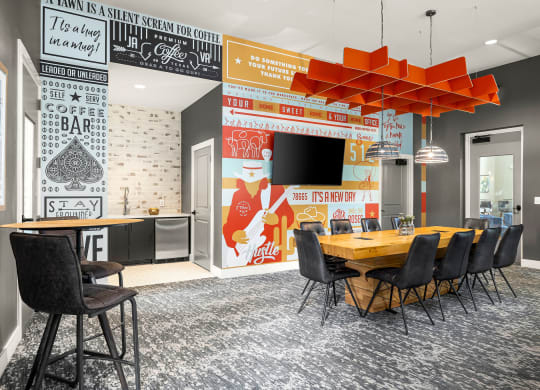 a conference room with a wooden table and chairs and a large wall mural